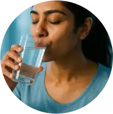 Post-Treatment Oral Care Tips Woman drinking water after dental treatment at the best dental clinic in Nagpur
